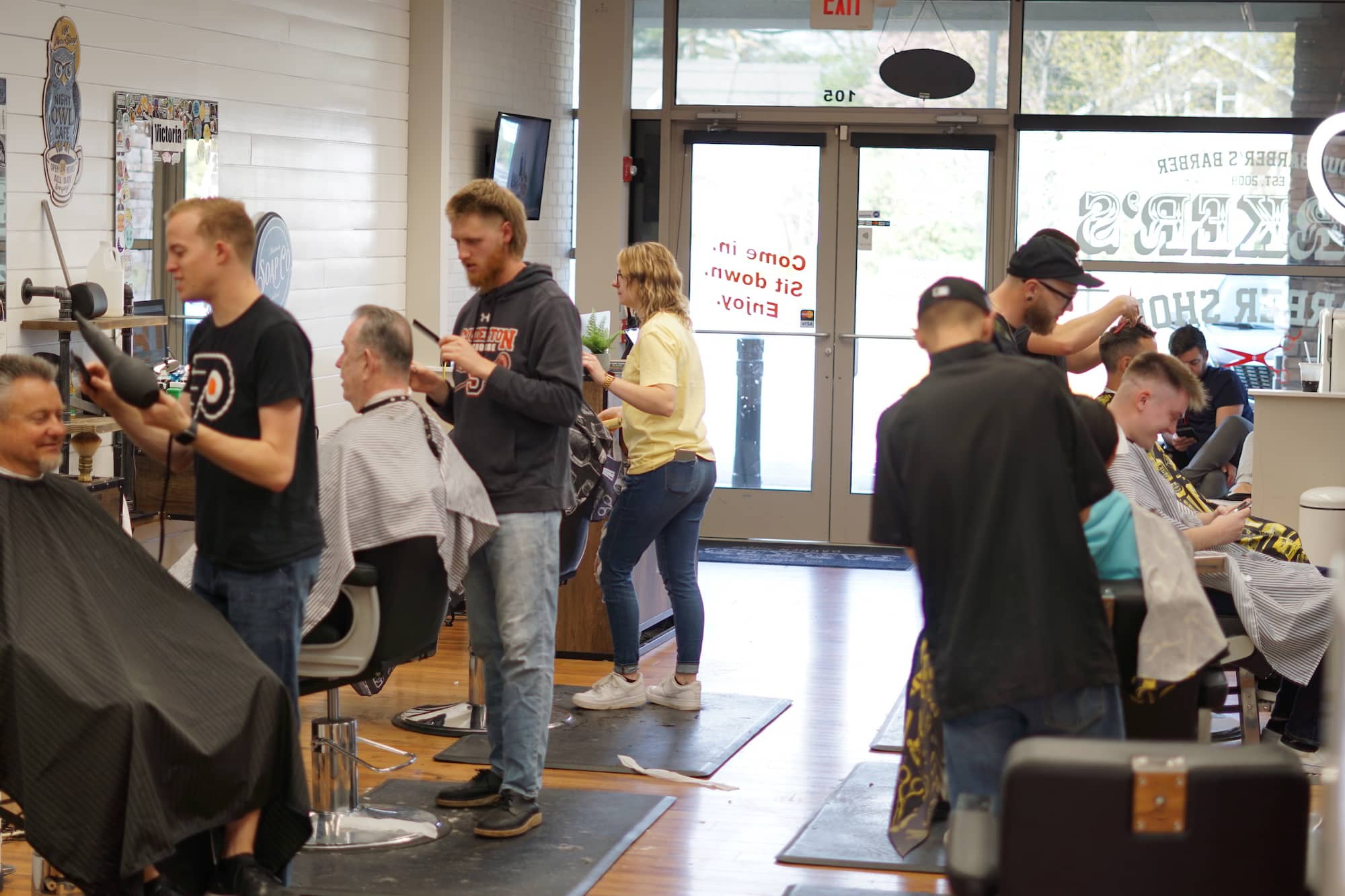 a barbershop full of people