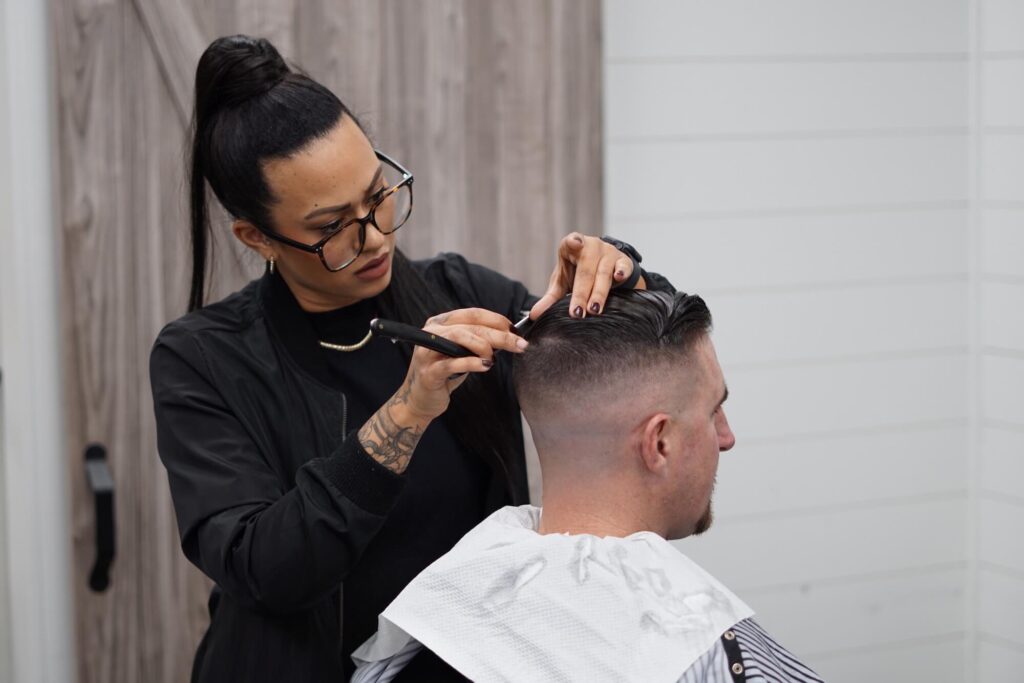 a woman cutting a man's hair