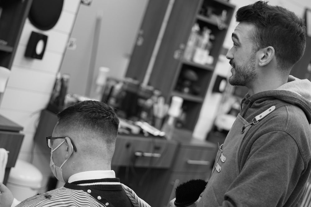 a barber talking to his client