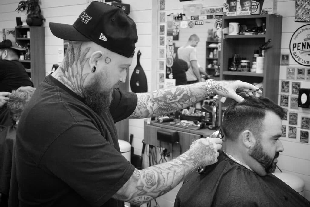 a barber cutting a man's hair